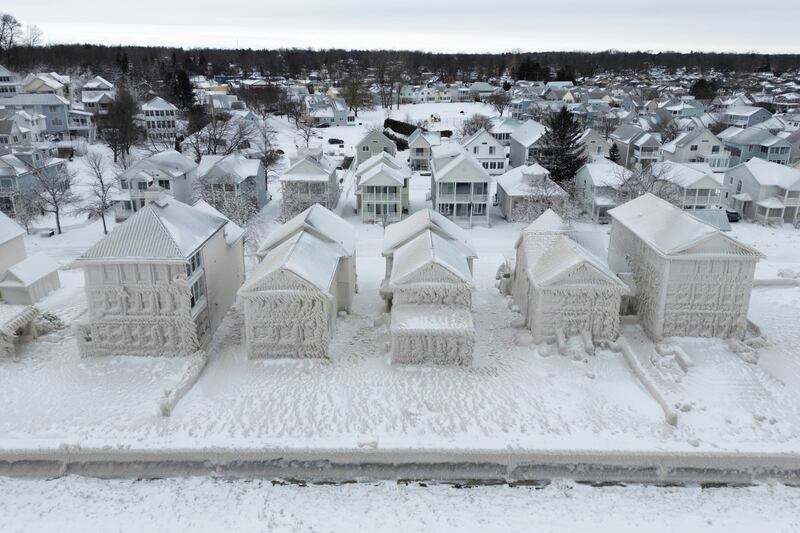 Houses along the shores of Lake Erie in Ontario are covered in ice following a storm, on December 27.  AP