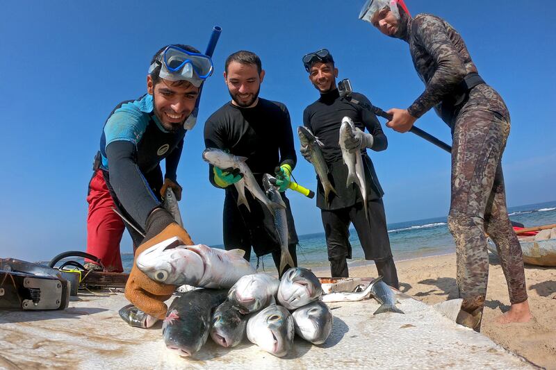 Palestinian spear-fisherman Ashraf Al-Amoudi displays fish on a beach in the southern Gaza Strip, October 8, 2020. Picture taken October 8, 2020. REUTERS/Suhaib Salem