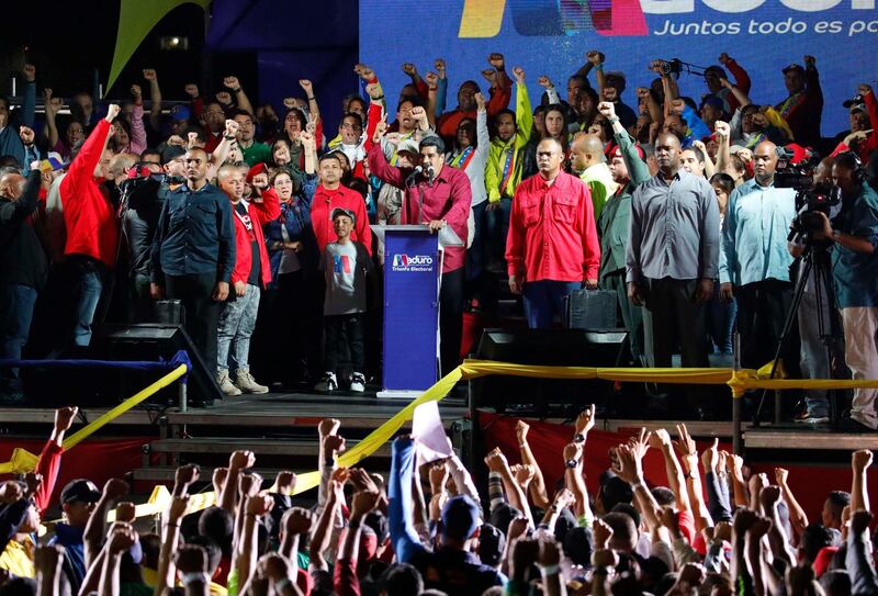 Venezuela's President Nicolas Maduro raises a finger as he is surrounded by supporters while speaking during a gathering after the results of the election were released, outside of the Miraflores Palace in Caracas, Venezuela. Carlos Garcia Rawlins / Reuters