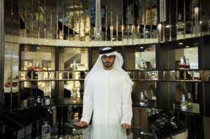 United Arab Emirates -Dubai- Aug. 12, 2009:

NATIONAL: Perfumer Mohamed Hilal (cq-al), 34, of Sharjah, poses for his portrait in front of his shop located inside the Paris Gallery store at the Dubai Festival City Centre mall in Dubai on Wednesday, Aug. 12, 2009. Hilal, a former pilot, went into the perfume business in 2001. "Perfume was my passion," said Hilal. "It's an obsession. I love it." Amy Leang/The National
 *** Local Caption ***  amy_081209_perfumer_07.jpg