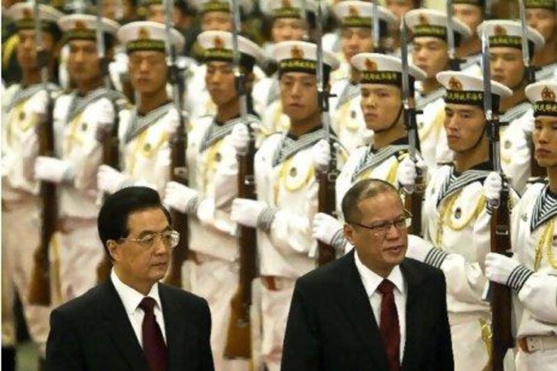 The Philippine president, Benigno Aquino, right, and the Chinese president, Hu Jintao, review an honour guard during a welcome ceremony for Mr Aquino at the Great Hall of the People in Beijing.