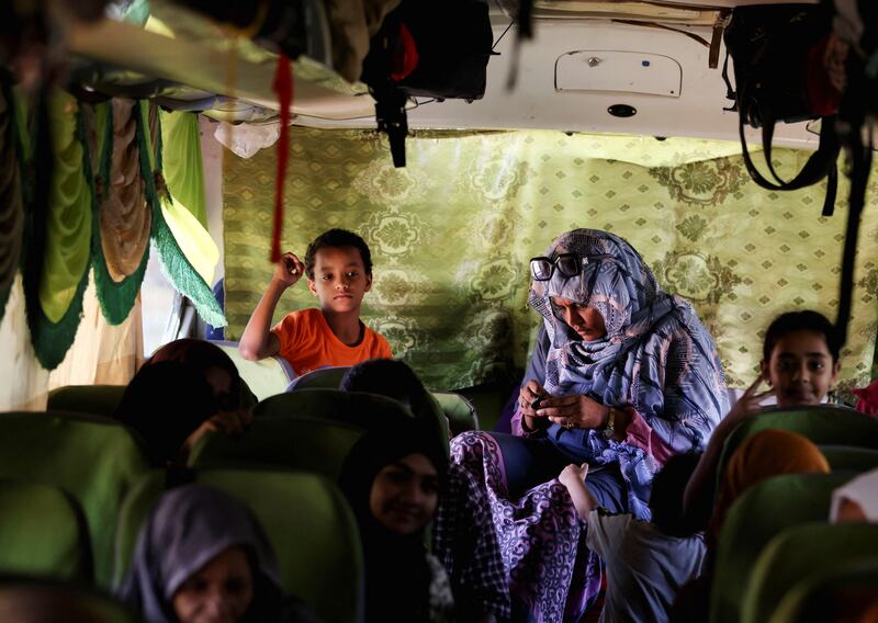 A family sits in a bus heading to Egypt. Reuters