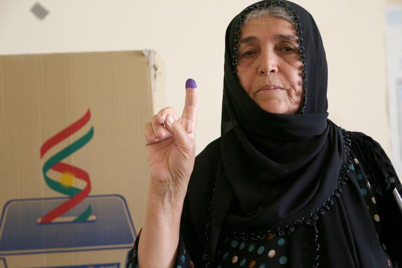 A Kurdish woman in traditional clothes shows her ink-marked finger after casting her vote in the Kurdistan parliamentary election at a polling station in Erbil, the capital of the Kurdistan Region in Iraq. With over three million people eligible to vote, the semi-autonomous region is voting on its parliamentary elections a year after a failed bid for independence from Iraq.  EPA