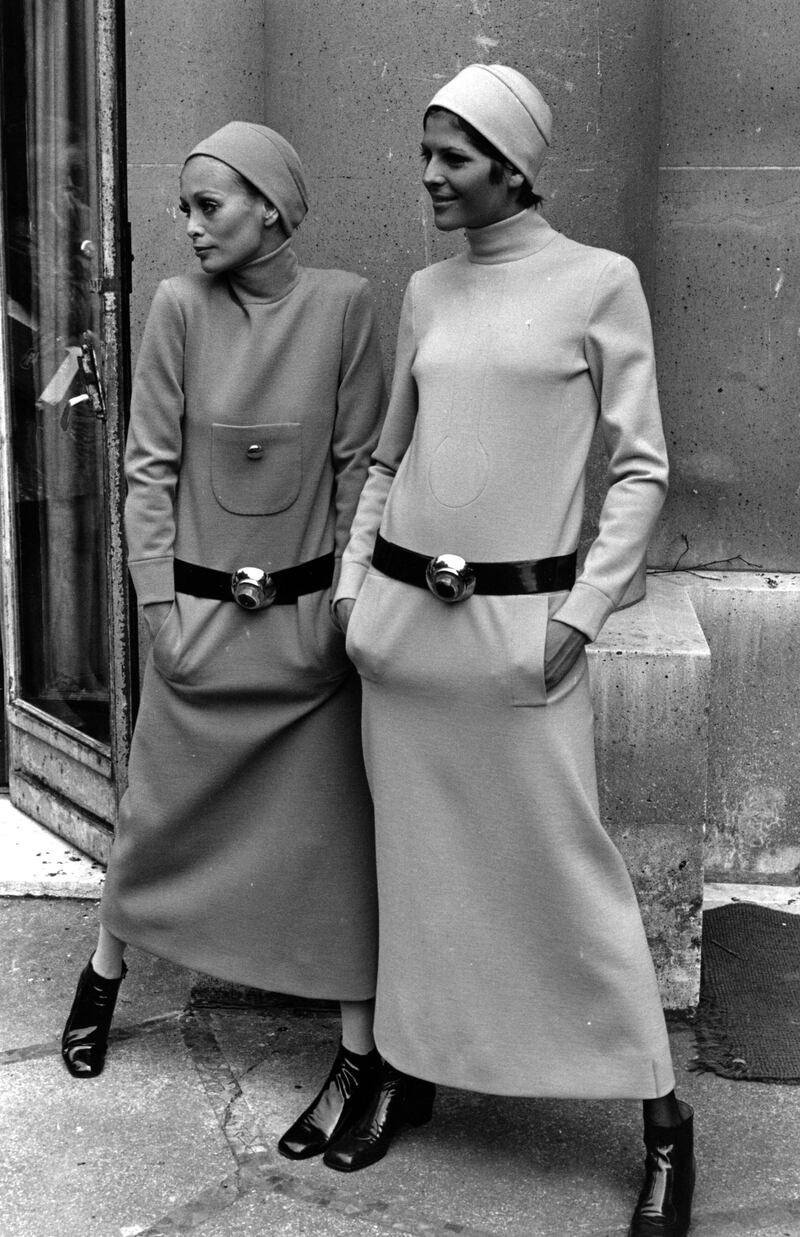 Two women model the Pierre Cardin fashions to be presented at the French Fashion Collection in April 1969. A long dress, long sleeves, high neck and no frills seems to be the fashion.   (Photo by Express Newspapers/Getty Images)