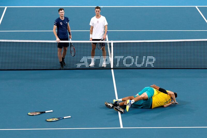 Alex de Minaur and Nick Kyrgios celebrate after beating Britain's Jamie Murray and Joe Salisbury in the ATP Cup doubles match in Sydney on Thursday, January 9. The victory sealed Australia a semi-final place. Reuters.