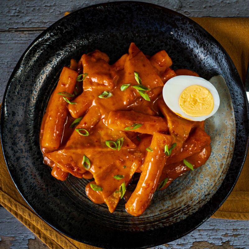 Traditional tteokbokki rice cakes are elevated by a creamy sauce