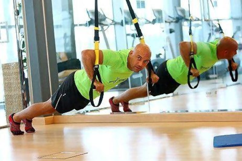 Guillaume Mariole of the Ignite Fitness and Wellness Club in Dubai demonstrates how the TRX straps can be used.