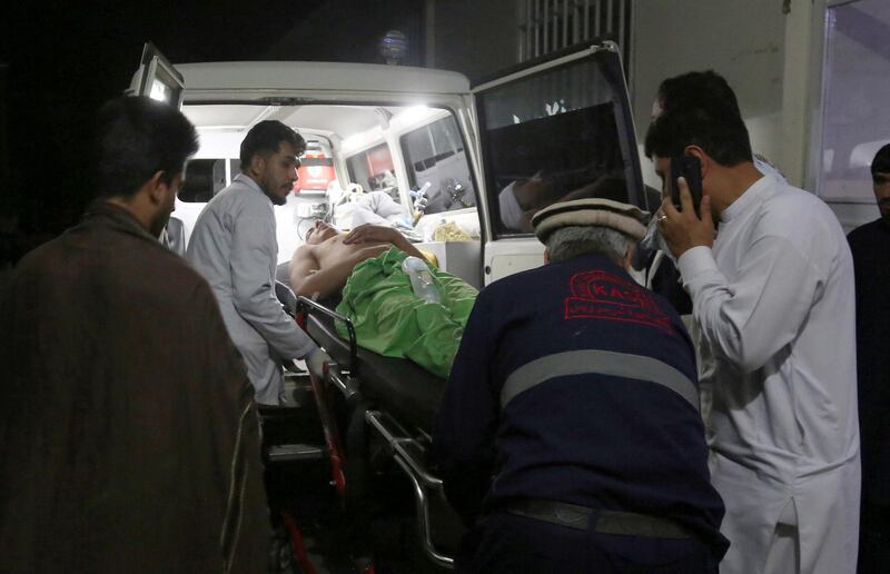 A wounded man is carried to a hospital after an explosion at wedding hall in Kabul, Afghanistan.  AP