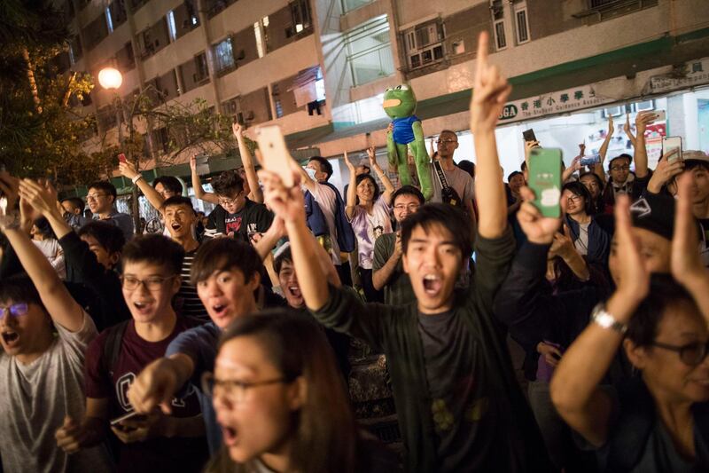 epa08023593 Pro-democracy supporters celebrate the defeat of pro-Beijing district councillor Junius Ho, in Tuen Mun, Hong Kong, China, 25 November 2019. Hong Kongâ€™s pro-democracy candidates rose to a landslide victory in the district council elections in a record voter turnout, sending a strong message to the government and its allies.  EPA/CHAN CHEUNK FAI