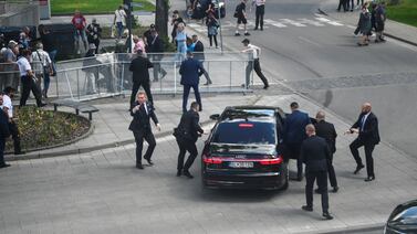 Prime Minister Robert Fico was bundled into a car by a bodyguard after a shooting in Handlova, Slovakia. Reuters