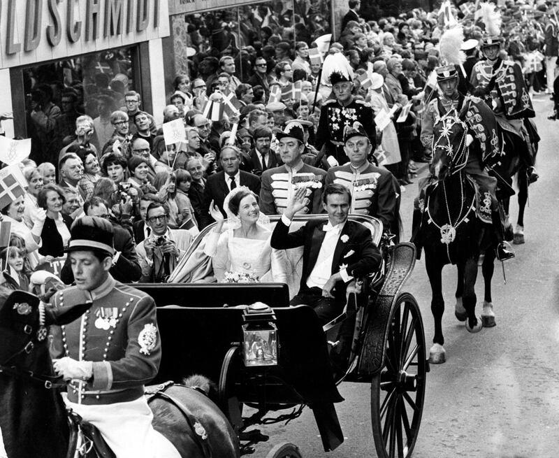 Princess Margrethe and Prince Henrik ride in a carriage through the streets of Copenhagen after their wedding in 1967. EPA