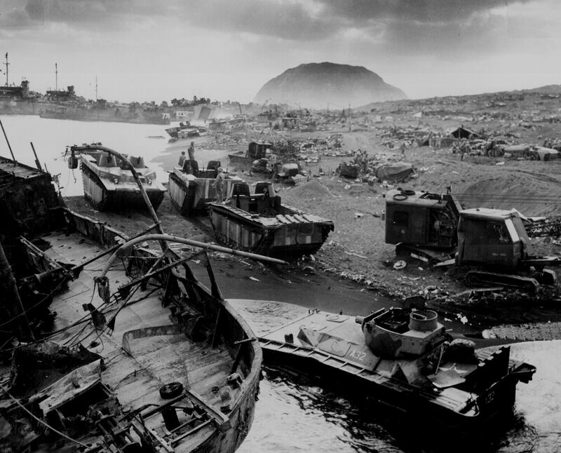 Wrecked US Marine vehicles litter an Iwo Jima beach, in 1945. Reuters