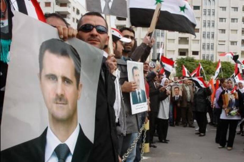Pro-Syrian regime protesters, hold portraits of Syrian President Bashar Assad and shout slogans against the Arab League, as they gather outside the Syrian foreign ministry where Syrian Foreign Minister Walid al-Moallem helds a press conference, in Damascus, Syria, on Monday Nov. 14, 2011. Syria's foreign minister accused Arab states on Monday of conspiring against Damascus after the Arab League voted to suspend Syria's membership over the government's deadly crackdown on an eight month-old uprising. (AP Photo/Muzaffar Salman) *** Local Caption ***  Mideast Syria .JPEG-065b9.jpg