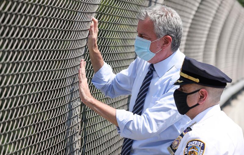 New York City Mayor Bill de Blasio talks with New York City Sheriff Joseph Fucito while visiting a Covid-19 checkpoint for drivers entering New York City over the Bayonne Bridge in Staten Island, New York.  EPA