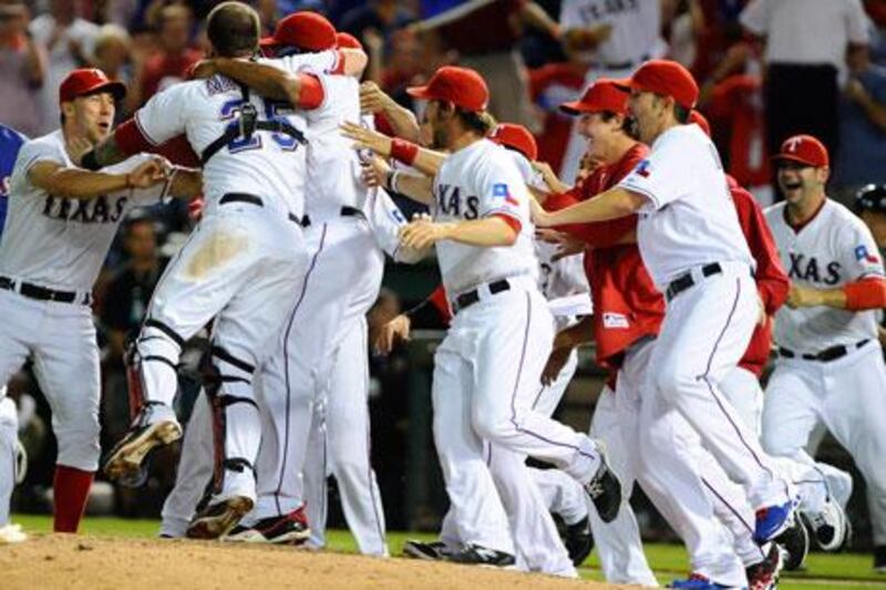 The Texas players mobbed the field in celebration after winning Game 6 of the American League Championship Series to eliminate the Detroit Tigers and reach the World Series for the second consecutive year.