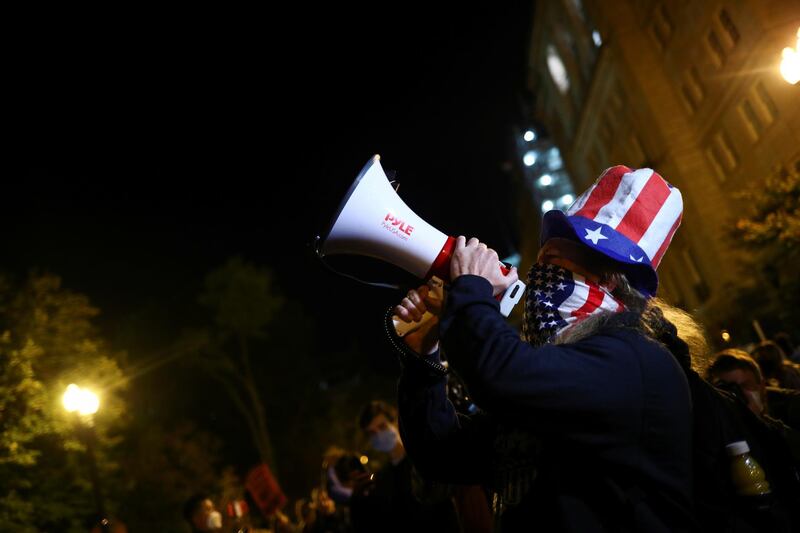 A supporter of U.S. Democratic presidential nominee Joe Biden uses a megaphone near the White House during Election Day in Washington. Reuters