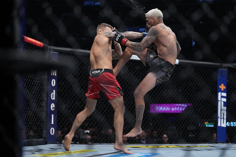 Charles Oliveira moves in with a hit against Dustin Poirier. Reuters