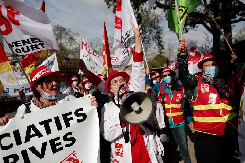 A protester rallies fellow health workers in Paris. Reuters