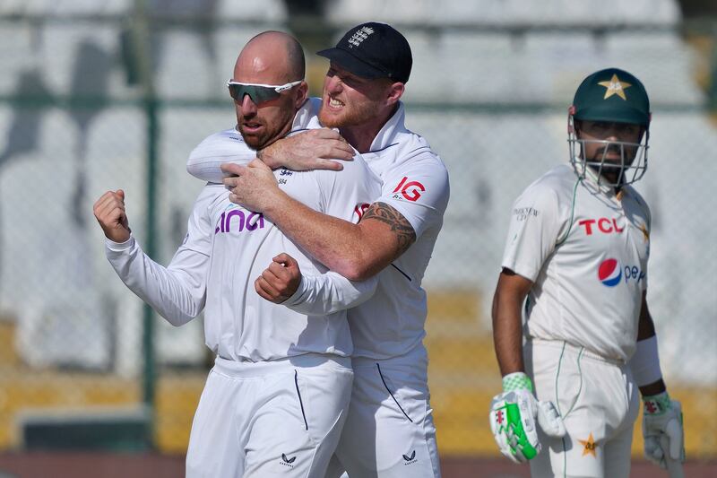 England's Jack Leach, left, celebrates with teammate Ben Stokes after taking the wicket of Pakistan's Abdullah Shafique. AP