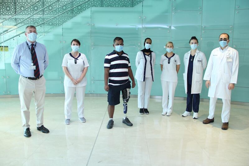 Hashan Ali and his doctors at Cleveland Clinic Abu Dhabi. The Bangladeshi shop worker was fitted with a prosthetic leg and underwent physiotherapy. Courtesy: Cleveland Clinic Abu Dhabi