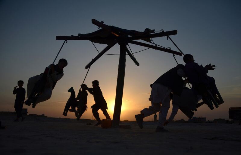 Playing on a swing at sunset on the outskirts of Mazar-i-Sharif, Afghanistan. Farshad Usyan / AFP