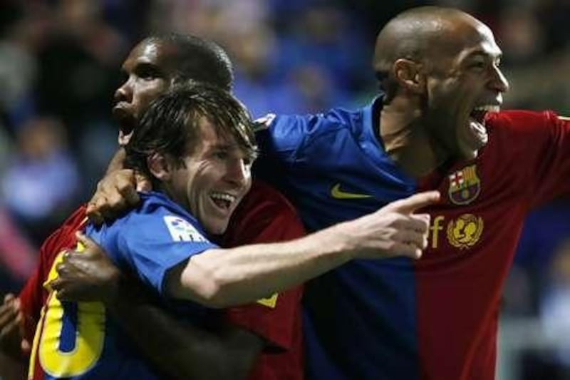 Lionel Messi, left, celebrates with teammates Thierry Henry, right, and Samuel Eto'o.