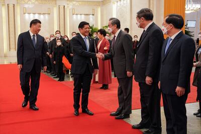 Ferdinand Marcos Jr shakes hands with Chinese officials in the presence of President Xi Jinping in Beijing, also in February. AFP
