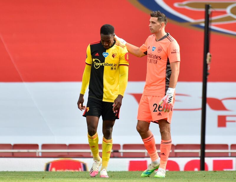 Arsenal goalkeeper Emiliano Martinez (R) comforts Watford's Danny Welbeck. EPA