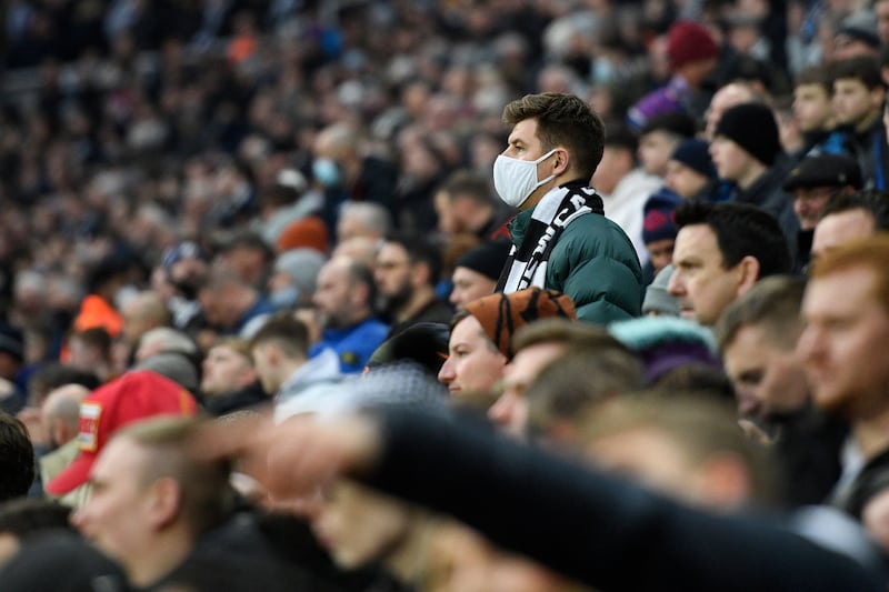 A fan wearing a face covering during the English Premier League football match between Newcastle United and Manchester City at St James' Park in Newcastle. AFP