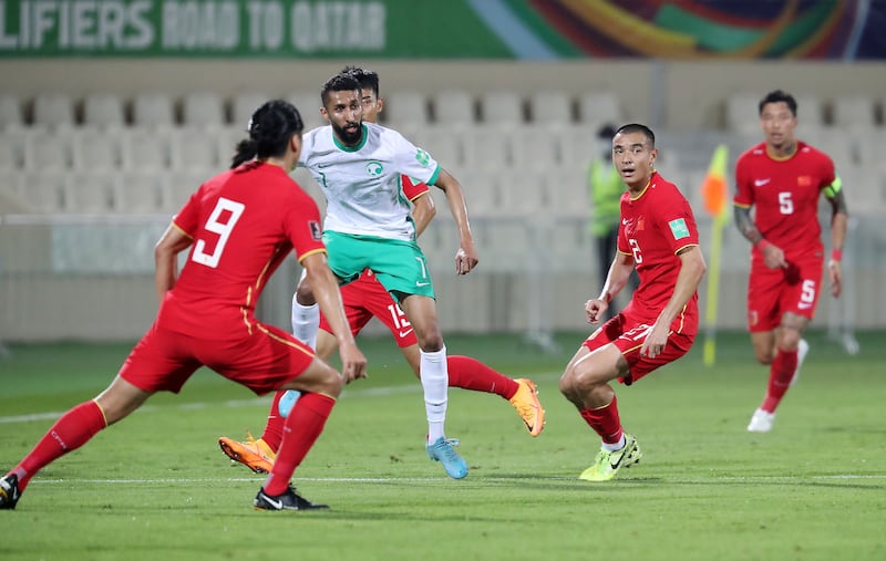 Salman Alfaraj is surrounded by China players. 