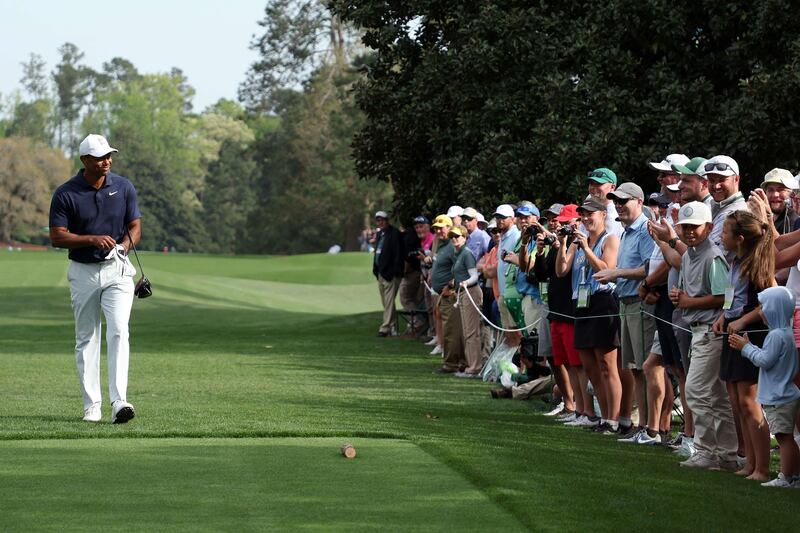 Tiger Woods walks to the ninth tee during a practice round prior to The Masters as hundreds of fans watch behind the ropes. AFP