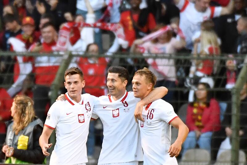 Poland's Robert Lewandowski, centre, celebrates with teammates after scoring against Belgium in a Uefa Nations League match in June, 2022. AP