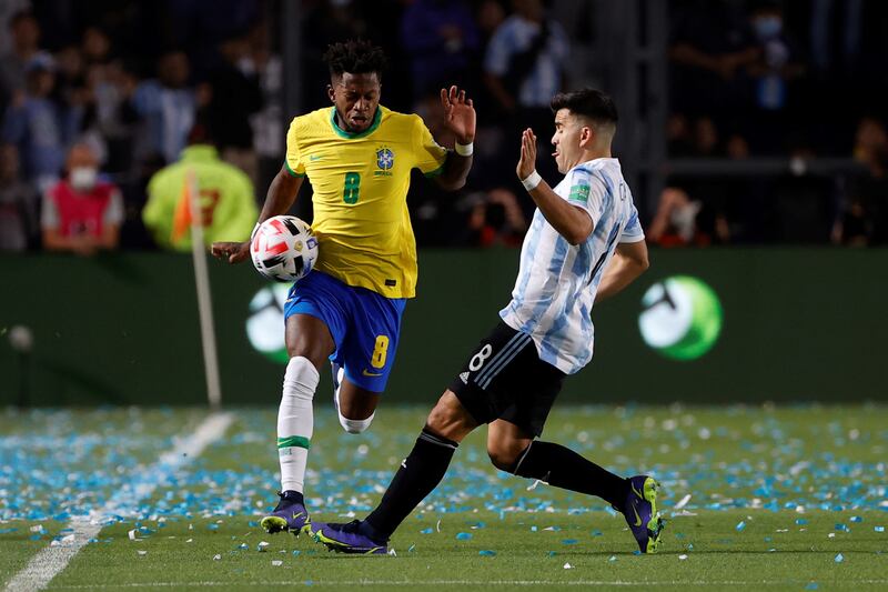 Argentina's Marcos Acuna battles for possession with Fred.  EPA