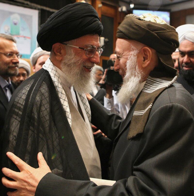 In this photo released by an official website of the Iranian supreme leader's office, Iranian supreme leader Ayatollah Ali Khamenei, left, greets former Afghan president Burhanuddin Rabbani, head of the Afghan High Peace Council, during an "Islamic Awakening" conference in Tehran, Iran, Saturday, Sept. 17, 2011. Former Afghan President Burhanuddin Rabbani, who headed a government peace council set up to facilitate contacts with Taliban insurgents, was assassinated Tuesday Sept. 20, 2011 by a suicide bomber concealing explosives in his turban, officials said. Four of Rabbani's bodyguards also died and a key presidential adviser was wounded.  (AP Photo/Office of the Supreme Leader) ** EDITORIAL USE ONLY, NO SALES ** *** Local Caption ***  Mideast Iran Afghanistan.JPEG-02f1e.jpg