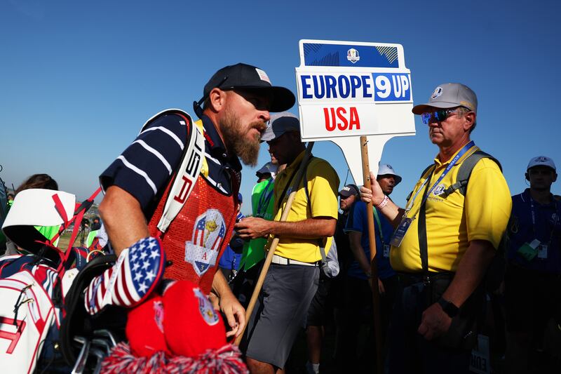 A walking scorer's board displays Europe "9 Up" for the victory of Viktor Hovland and Ludvig Aberg of Team Europe. Getty