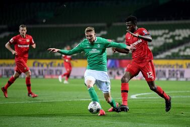 Bremen's German forward Nick Woltemade (C) and Leverkusen's Burkinabe defender Edmond Tapsoba vie for the ball during the German first division Bundesliga football match Werder Bremen v Bayer 04 Leverkusen on May 18, 2020 in Bremen, northern Germany as the season resumed following a two-month absence due to the novel coronavirus COVID-19 pandemic. - DFL REGULATIONS PROHIBIT ANY USE OF PHOTOGRAPHS AS IMAGE SEQUENCES AND/OR QUASI-VIDEO / AFP / POOL / Stuart FRANKLIN / DFL REGULATIONS PROHIBIT ANY USE OF PHOTOGRAPHS AS IMAGE SEQUENCES AND/OR QUASI-VIDEO