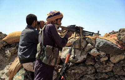 Fighters loyal to Yemen's Saudi Arabia-backed government guard a position near the frontline facing Houthi rebels in the country's north-east province of Marib, on October 17, 2021.  AFP