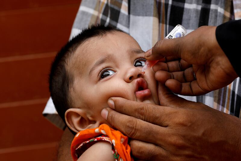 A girl receives vaccine drops during an anti-polio campaign in a low-income neighbourhood in Karachi. Reuters