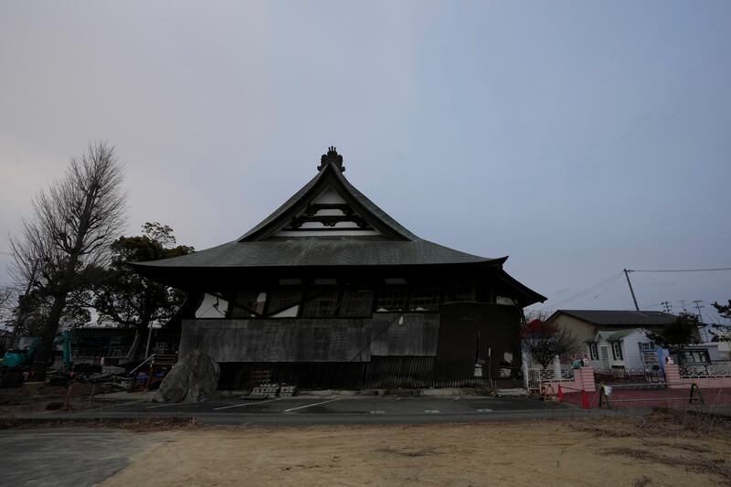 A damaged Buddhist temple and a kindergarten lie abandoned. AP