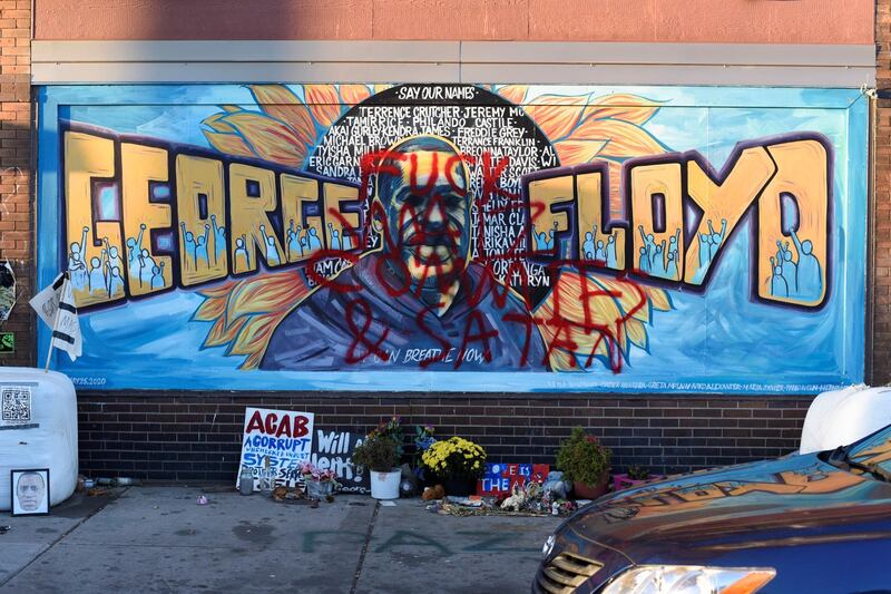 A vandalized mural at the George Floyd Memorial site is seen following the release of former Minneapolis police officer Derek Chauvin, after he posted bail ,in Minneapolis, Minnesota, U.S. October 7, 2020.  REUTERS/Nicholas Pfosi