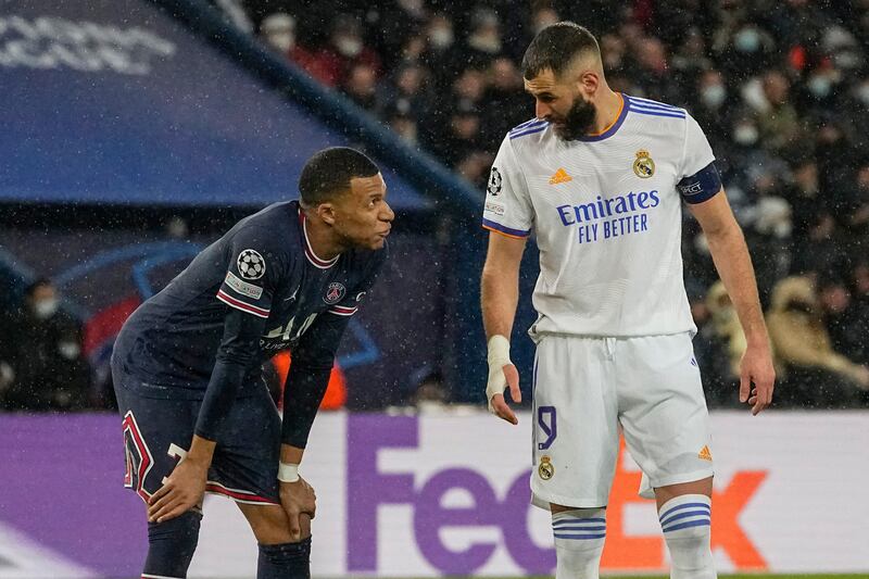 PSG's Kylian Mbappe, left, talks with Karim Benzema of Real Madrid during the Champions League last-16, first leg in 2022. AP