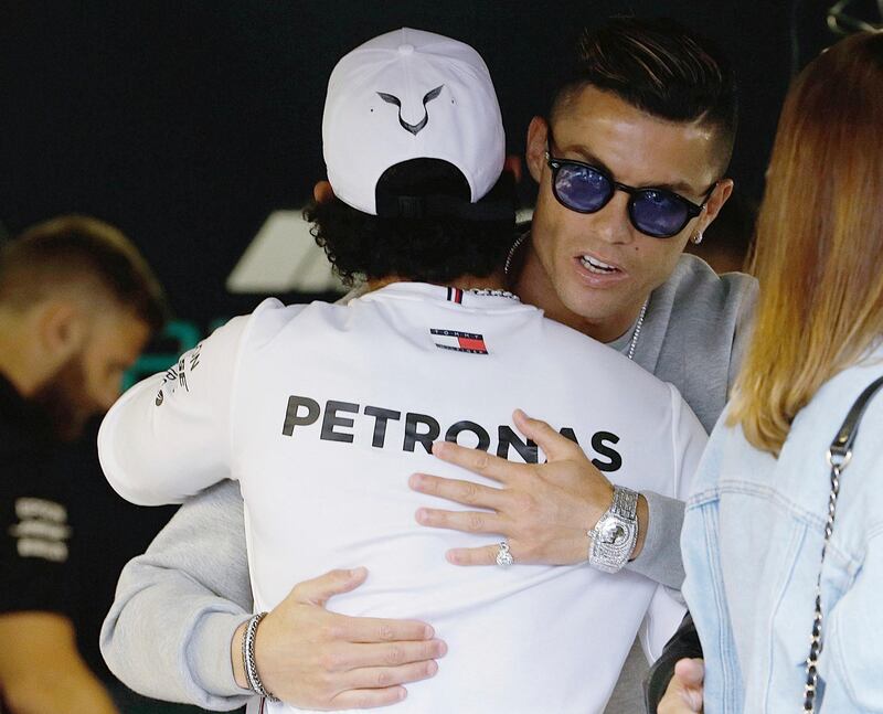 Ronaldo shares an embrace with Hamilton. AP Photo