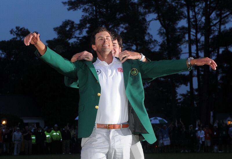 Bubba Watson of the US presents Adam Scott of Australia a Green Jacket during the Green Jacket Ceremony at 77th Masters golf tournament at Augusta National Golf Club on April 14, 2013 in Augusta, Georgia. Scott sank a 10-foot birdie putt on the second playoff hole Sunday to beat Angel Cabrera and win the 77th Masters, becoming the first Australian golfer to capture the green jacket. AFP PHOTO/Jewel Samad
 *** Local Caption ***  912115-01-08.jpg