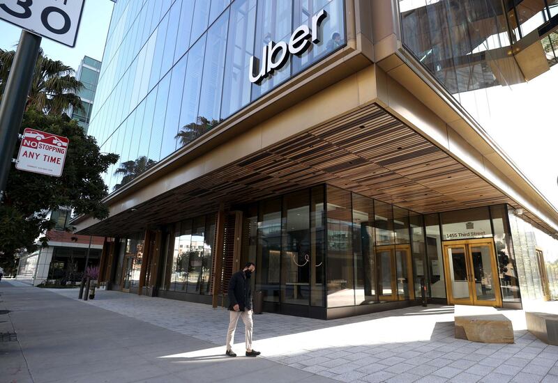 SAN FRANCISCO, CALIFORNIA - MARCH 29: A pedestrian walks by the new Uber headquarters on March 29, 2021 in San Francisco, California. Uber is allowing some employees to return to work at their newly opened headquarters that was completed during the pandemic. San Francisco has entered the orange tier of reopening which allows non-essential offices to open at 25% capacity.   Justin Sullivan/Getty Images/AFP
== FOR NEWSPAPERS, INTERNET, TELCOS & TELEVISION USE ONLY ==
