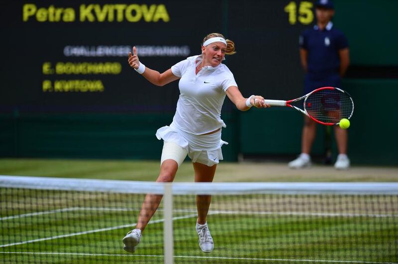 Petra Kvitova returns to Eugenie Bouchard during her victory on Saturday in the women's singles final at the 2014 Wimbledon Championships. Carl Court / AFP