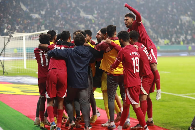 Qatar's Tameem Mansour Al Abdullah celebrates with teammates after scoring against the UAE. AP