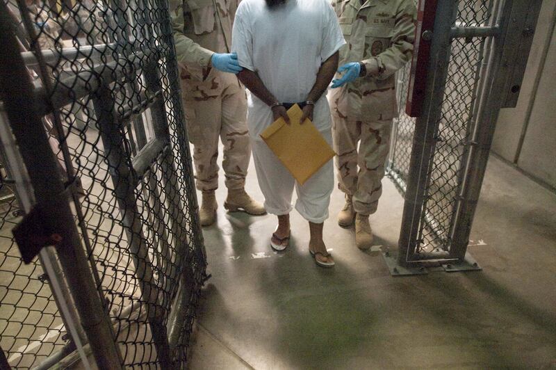 United States military guards move a detainee inside Camp VI at Guantanamo Bay, Cuba. Paul J Richards / AFP Photo