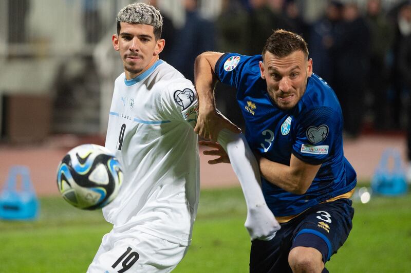 Kosovo's defender #03 Fidan Aliti (R) fights for the ball with Israel's forward #19 Dor Turgeman during the UEFA Euro 2024 Group I qualifying football match between Kosovo and Israel at the Fadil-Vokrri stadium in Pristina on November 12, 2023.  (Photo by ARMEND NIMANI  /  AFP)