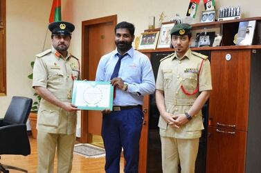 Dubai bus driver Abhishek Nad Gobindhan receives a certificate of thanks from Dubai Police. Courtesy: Dubai Police      