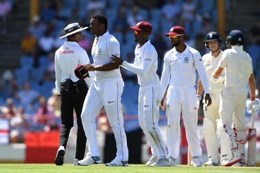 Shannon Gabriel, left, of the West Indies is ushered away by Kraigg Brathwaite after confronting England batsmen Joe Root and Joe Denly. Getty